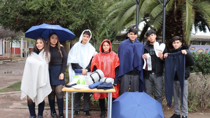 Estudiantes de liceos Red SOFOFA utilizando kits de lluvia para asistir a clases durante días de precipitaciones.