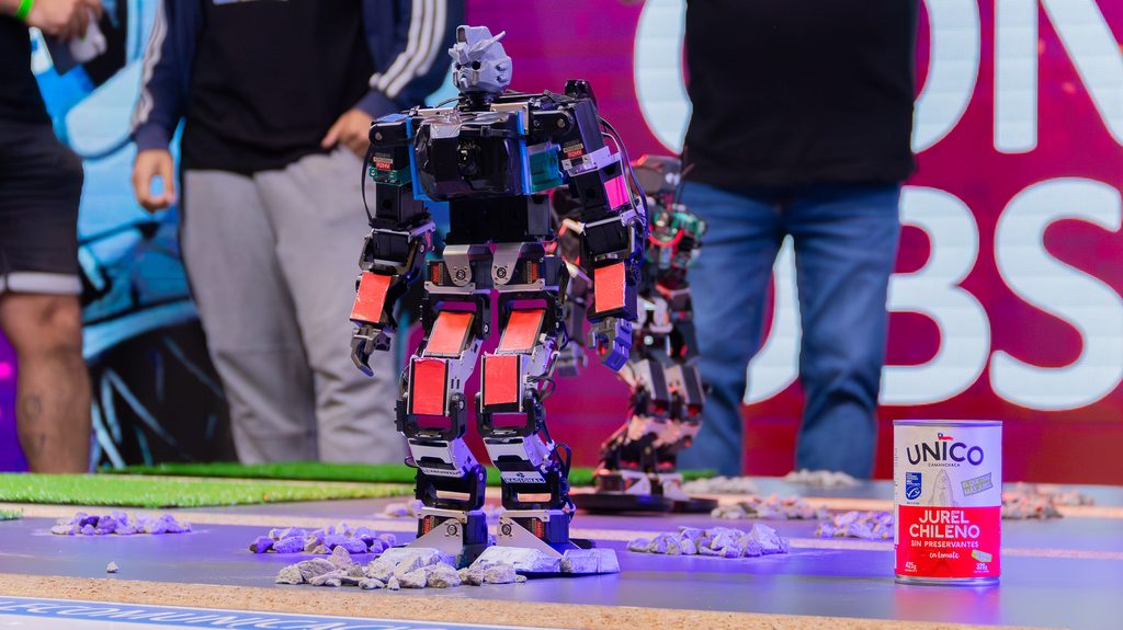 Estudiantes participando en competencias de robótica y tecnología en el evento Arena IV en Concepción.